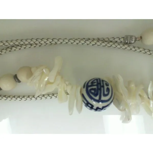 Necklace w/ white leather cord, Mother of pearl, wood beads and One large porcelain bead. apx 40