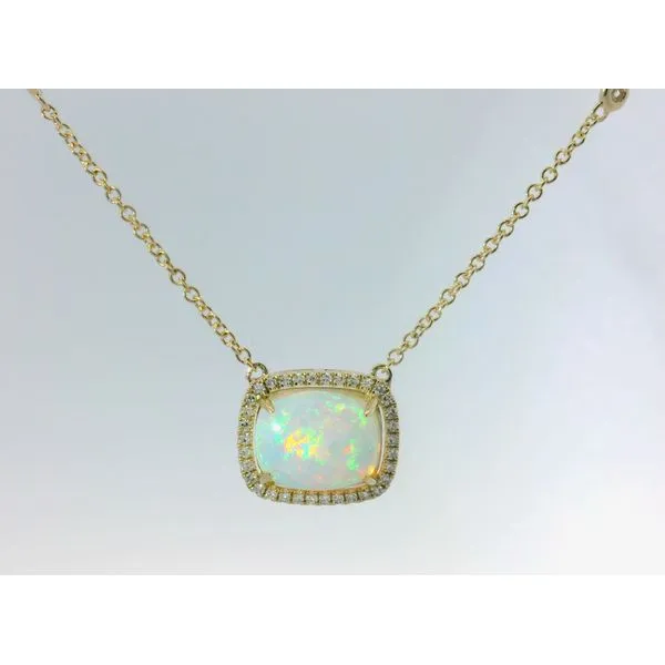 Looking to steal some glances? This dazzling pendant wraps a dreamy opal in a sparkling diamond halo—sure to turn every head your way. Albert's Jewelers Kingsland, GA