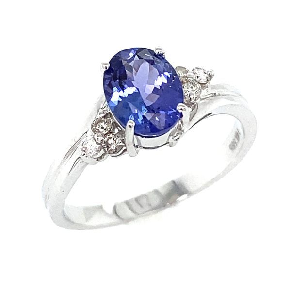 White gold ring with an oval tanzanite framed by small diamonds