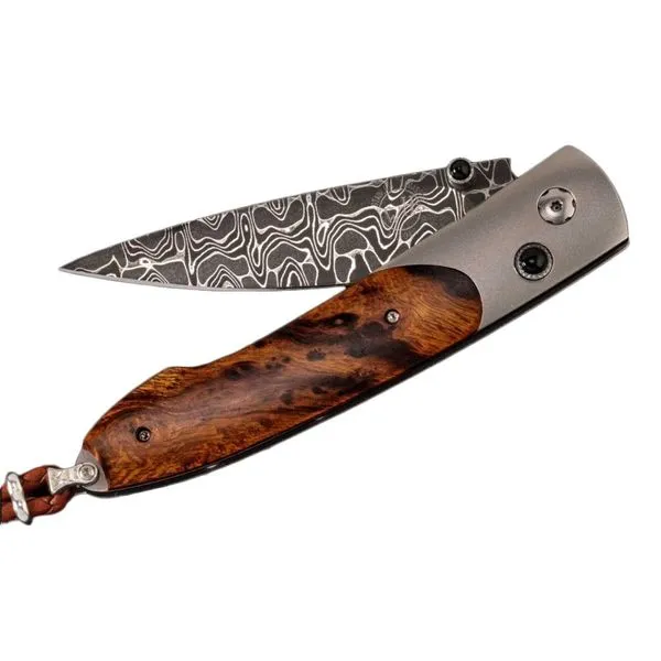 Lancet Rockledge features aerospace grade titanium inlaid with desert ironwood. The blade is Intrepid damascus, and the button l Holliday Jewelry Klamath Falls, OR