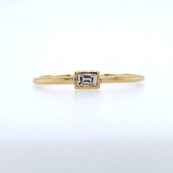 14k yellow gold hand fabricated thin band featuring a 0.10ct straight baguette diamond flush/bezel set in an east-west setting. Hudson Valley Goldsmith New Paltz, NY
