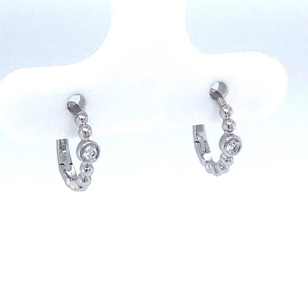 14k white gold small huggie earrings with bubble design featuring 0.04cttw diamonds bezel set in center of earring. Hudson Valley Goldsmith New Paltz, NY