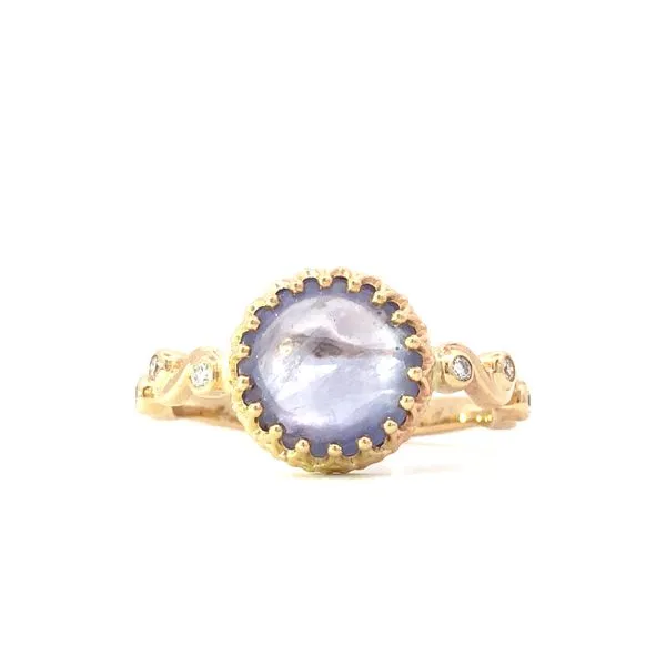 This 14K yellow gold squiggle ring features a stunning purple sapphire cabachon center stone and is accented with 0.10 carats total weight of bezel set diamonds. A unique and eye-catching piece of colored stone jewelry. Hudson Valley Goldsmith New Paltz, NY