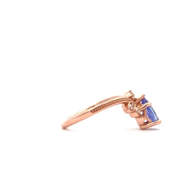 Crafted in 14K rose gold, this V ring showcases a beautiful purple tanzanite pear shaped center stone. Five small white diamonds add a touch of sparkle to this elegant colored stone ring. Image 3 Hudson Valley Goldsmith New Paltz, NY