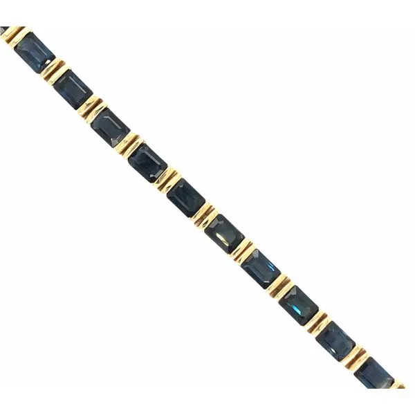 14k yellow gold bracelet featuring twenty-seven 4.5 x 3mm emerald cut blue sapphires, approximately 8cttw. The bracelet measures Hudson Valley Goldsmith New Paltz, NY