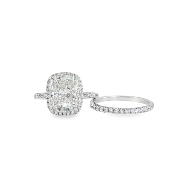 14 Karat White Gold 4.58ct tw Lab Grown Diamond Engagement Ring and Matching Band. The Center stone is a 3.95ct Cushion Cut, F in color and VS1 in clarity, with Accent Diamonds and Diamond Band that are .63ct tw, also F in Color and VS1 in clarity.  Total Jeff Dennis Jewelers Gardendale, AL