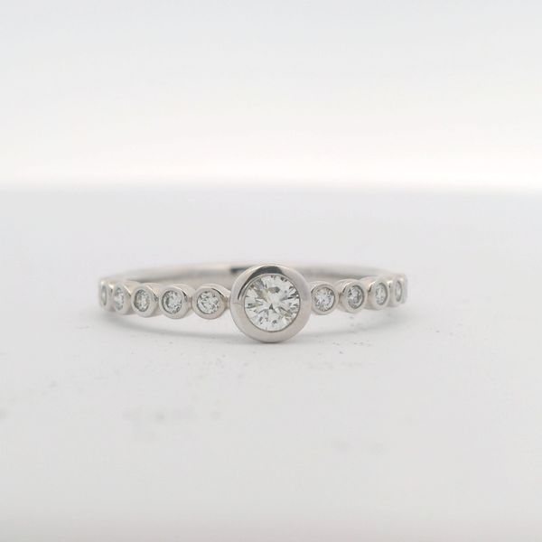 14KT W/G BEZEL SET DIAMOND BAND WITH CENTER ROUND STONE, 5 DIAMONDS ON ONE SIDE , 6 DIAMONDS ON ONE SIDE, -..23 CTTW G/H SI2 Lennon's W.B. Wilcox Jewelers New Hartford, NY