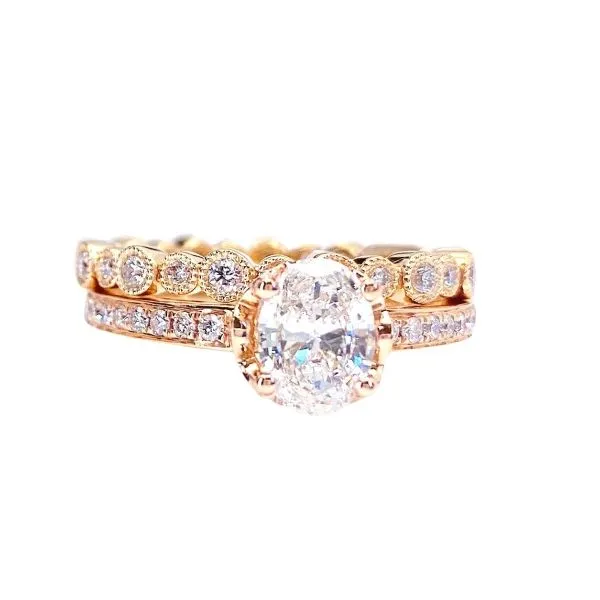 Oval Diamond solitaire ring on a diamond accented band