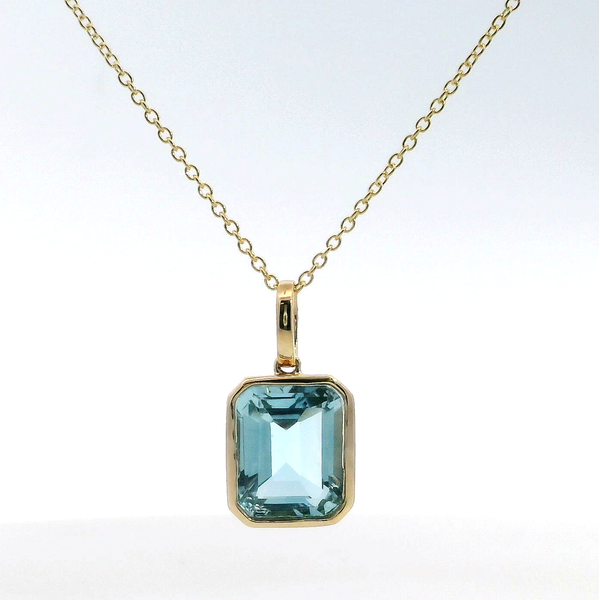 18K YG Blue Topaz Emerald Cut Bezel Pendant Saxons Fine Jewelers Bend, OR