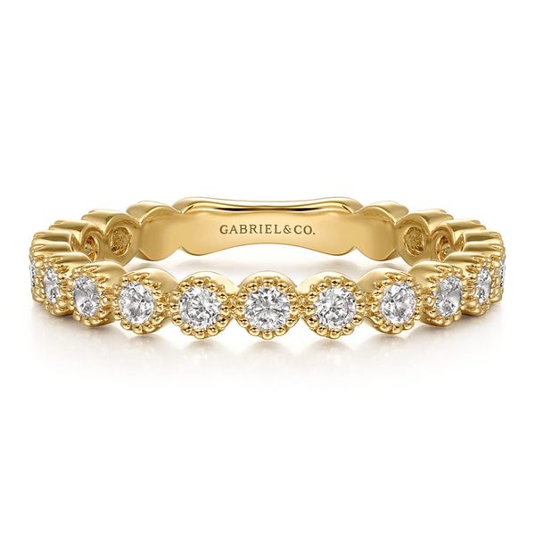 Gabriel & Co. 14K yellow gold bezel set diamond wedding band with milgrain detail