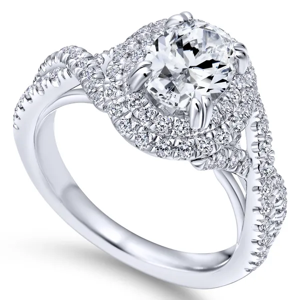 Modern engagement ring featuring two pave diamond halos looped around the oval cut center stone, plus a band of criss crossing diamond ribbons The Ring Austin Round Rock, TX