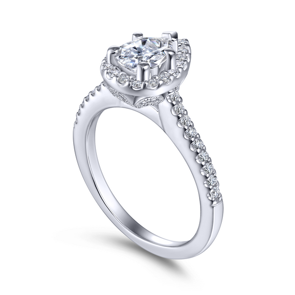 Pear shaped engagement ring features beautiful pave diamonds in the halo and on the band The Ring Austin Round Rock, TX