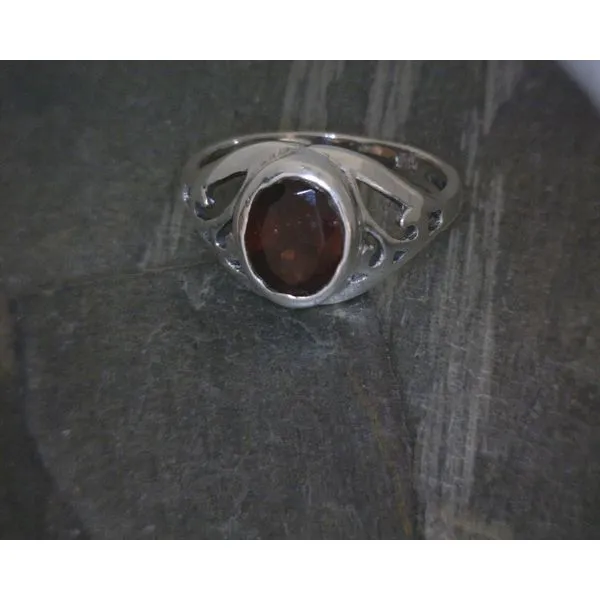 Ss Oval Faceted Garnet W/ Cutout Scroll Band Vulcan's Forge LLC KANSAS CITY, MO