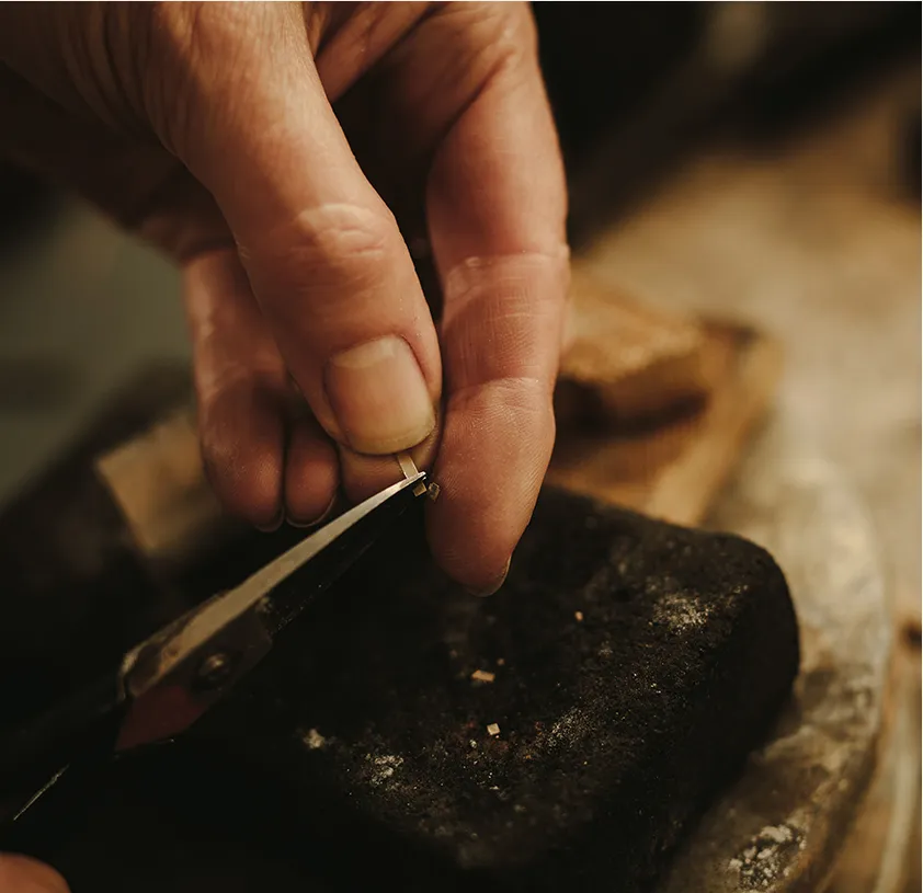 Jeweler using tools to make custom pieces