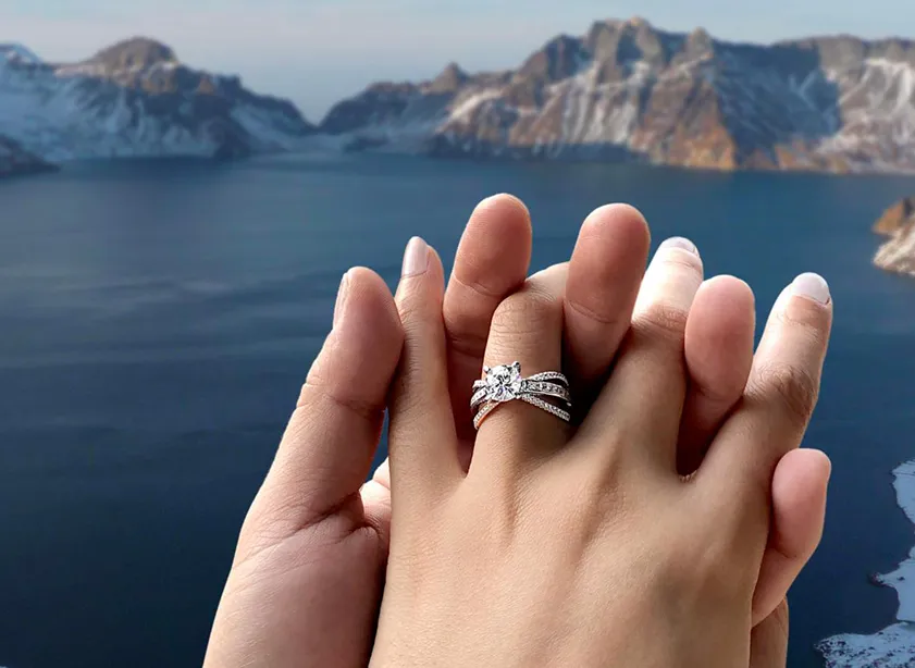 Closeup of custom engagement ring on a woman's hand