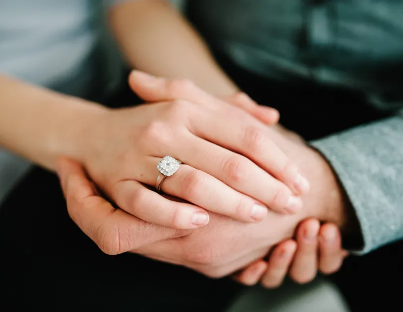 Hands Embracing While Wearing a Diamond Ring
