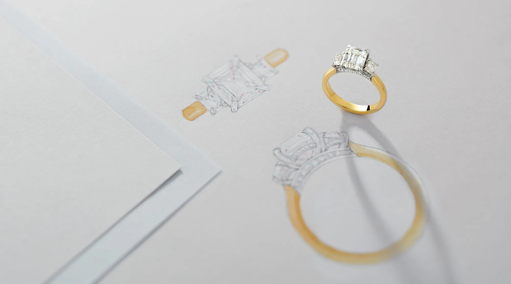 Custom jewelry design featuring a diamond engagement ring next to its sketch. 