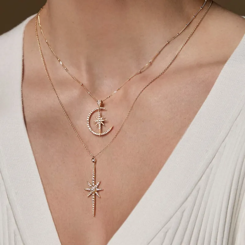 Gold layered necklaces featuring a crescent moon and star pendants.