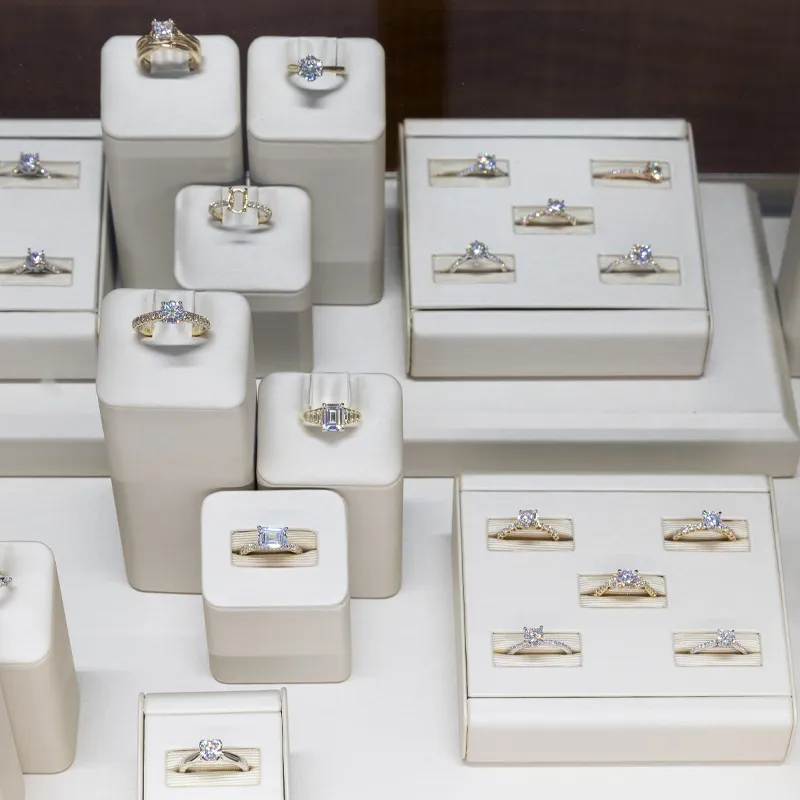 Display of elegant gold and diamond engagement rings at Ambassador Diamond Jewelers in Tucson.