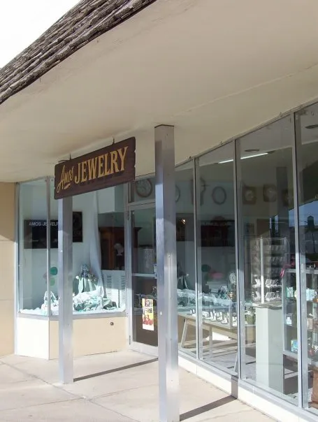 Amos Jewelry storefront with a sign, showcasing fine jewelry and engagement rings in Wray.