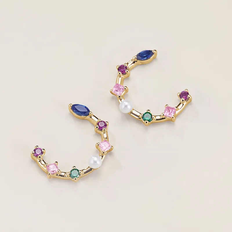 Colorful gemstone earrings with gold accents, featuring various shapes and a pearl.