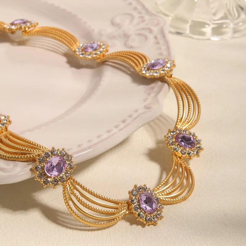 Elegant gold necklace with purple stones and intricate design, perfect for estate jewelry.