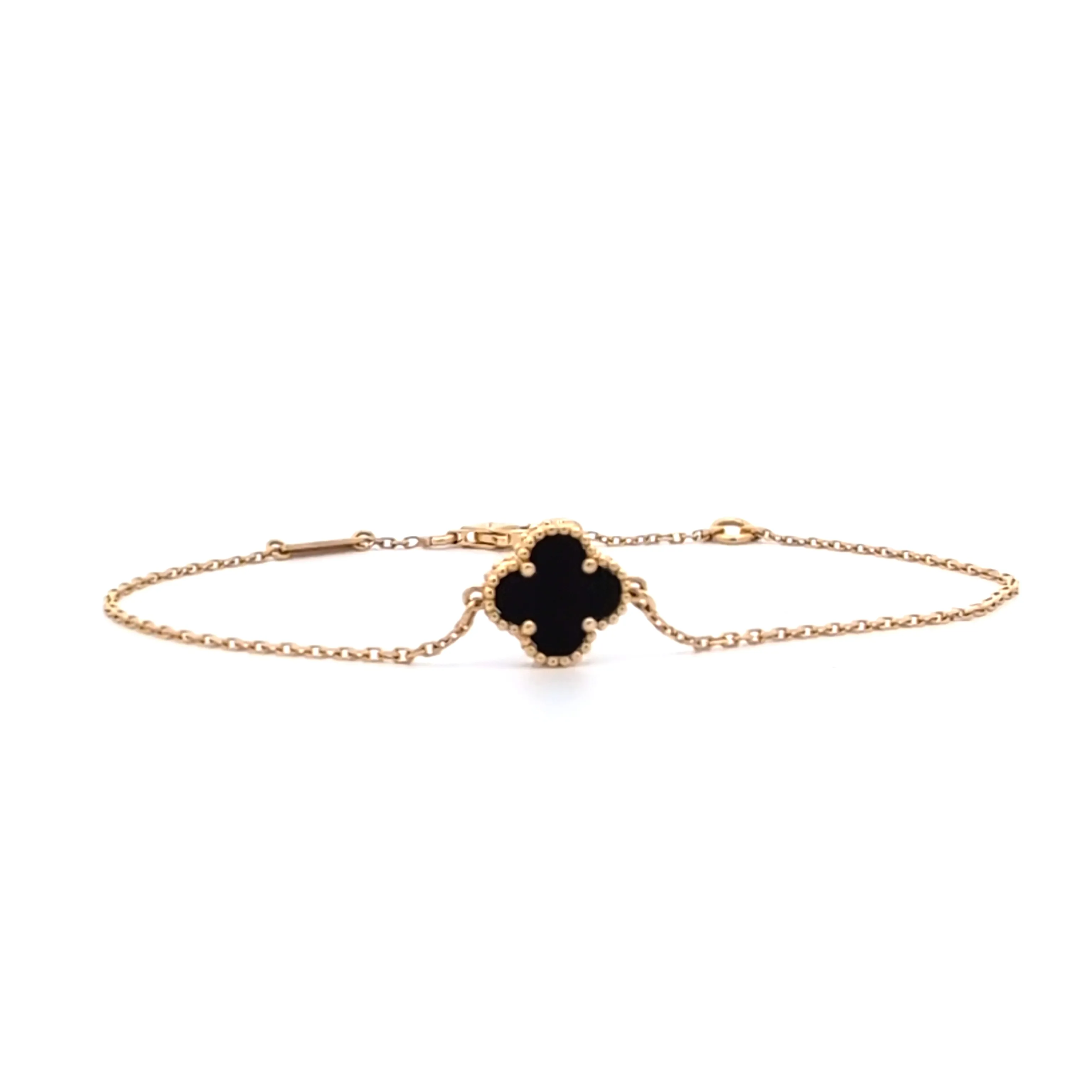 Elegant gold bracelet with black clover-shaped charm from Arezzo Jewelers.