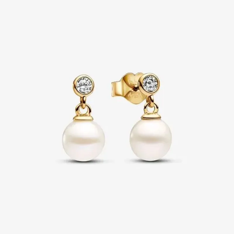 Elegant gold earrings featuring a pearl drop and sparkling diamond accents. Shop now at Arezzo Jewelers, Elmwood Park.
