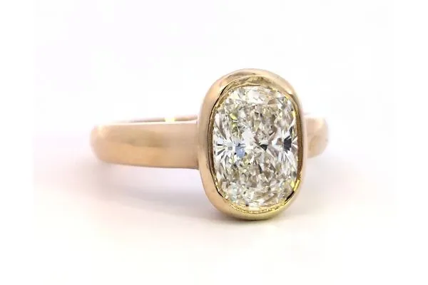 Elegant gold ring featuring a large, sparkling oval diamond centerpiece. Click to explore more at Arezzo Jewelers.