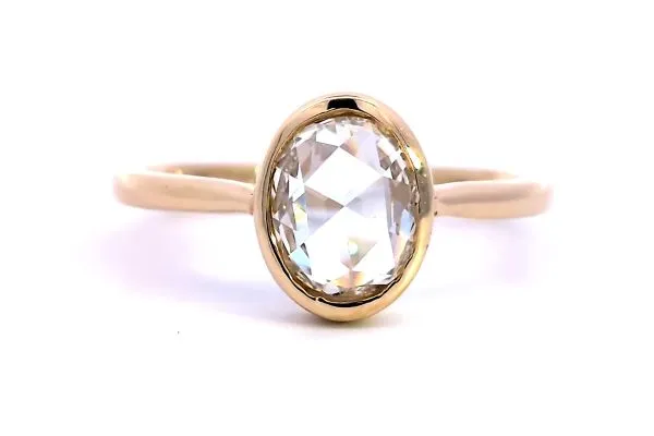 Elegant gold engagement ring with an emerald-cut center stone and diamond accents, inspired by Taylor Swift. Click to view.