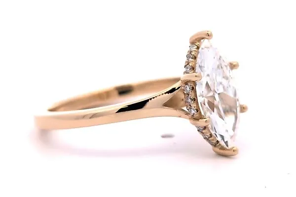 Elegant gold engagement ring with a large diamond and smaller stones on the band. Click to view more at Arezzo Jewelers.