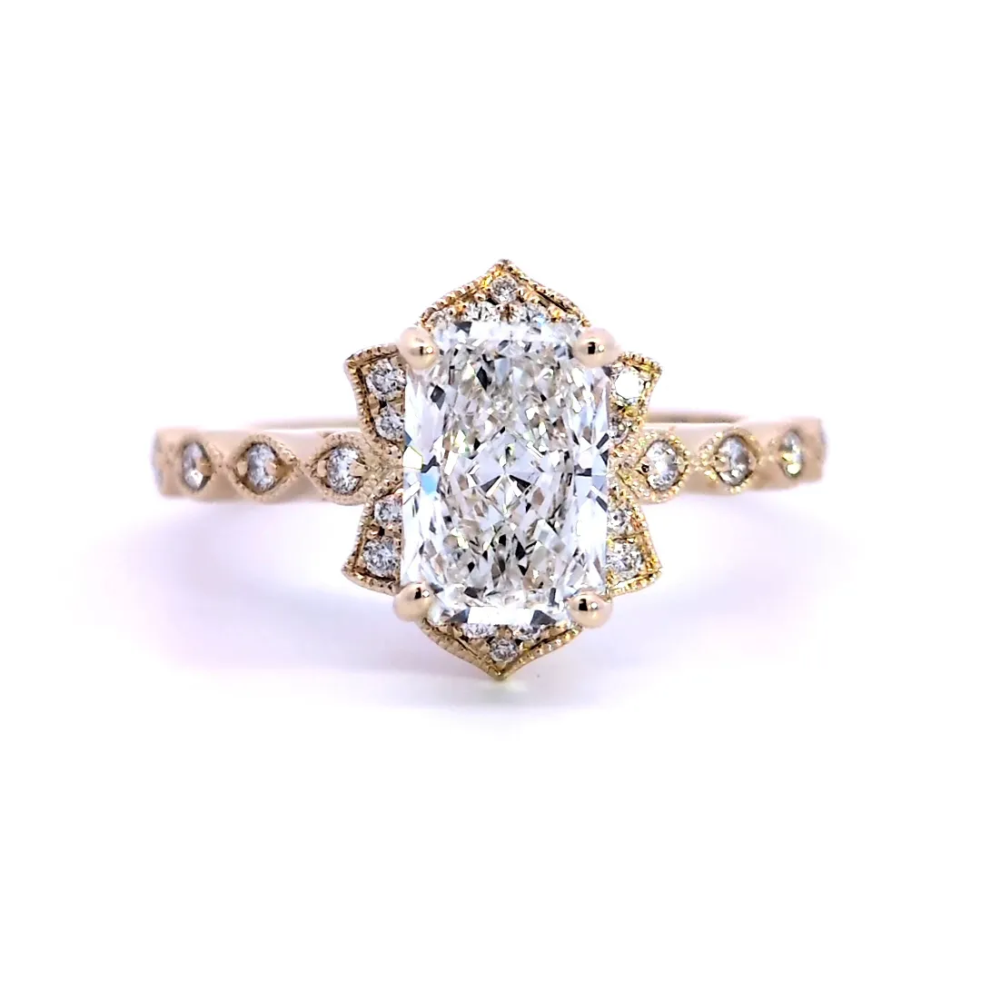 Elegant gold engagement ring with emerald-cut diamond and accents. Click to view details at Arezzo Jewelers.