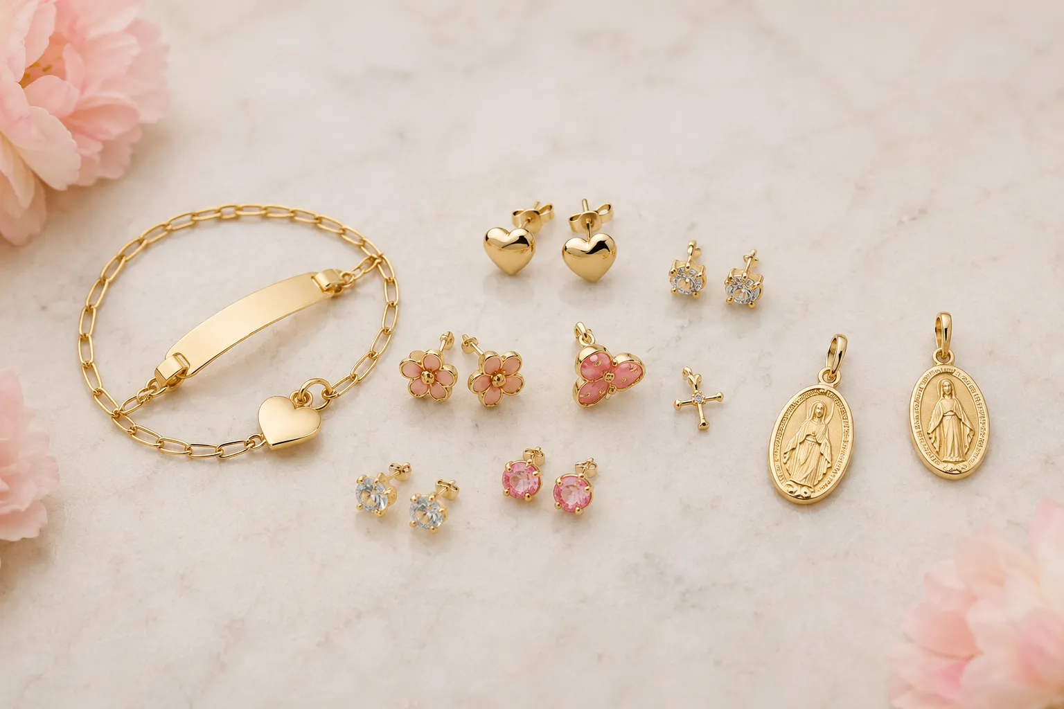 Assortment of children's gold jewelry including an ID bracelet, heart earrings, flower earrings, cross and religious medals