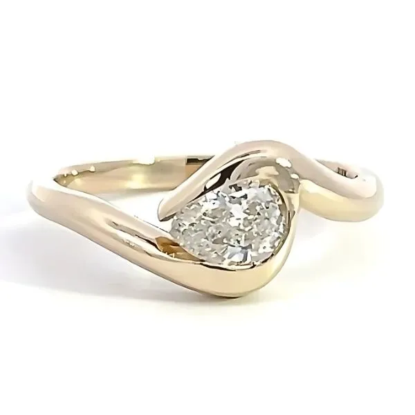Elegant gold ring with a sparkling pear shape diamond, with a modern twist design. Visit Arezzo Jewelers for more details.
