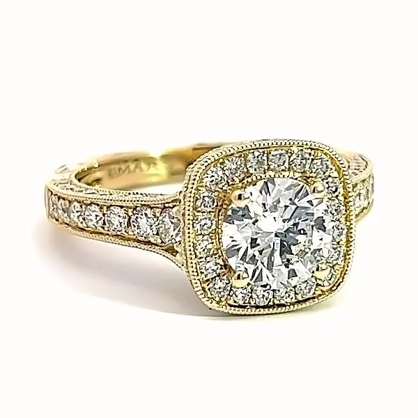 Vintage halo engagement ring with a round diamond center and intricate gold detailing. Click to view more at Arezzo Jewelers.