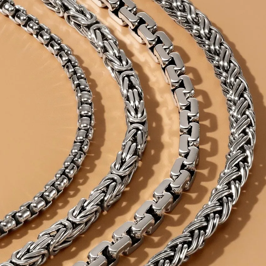 Four stylish silver bracelets displayed on a beige background, showcasing different designs and textures.