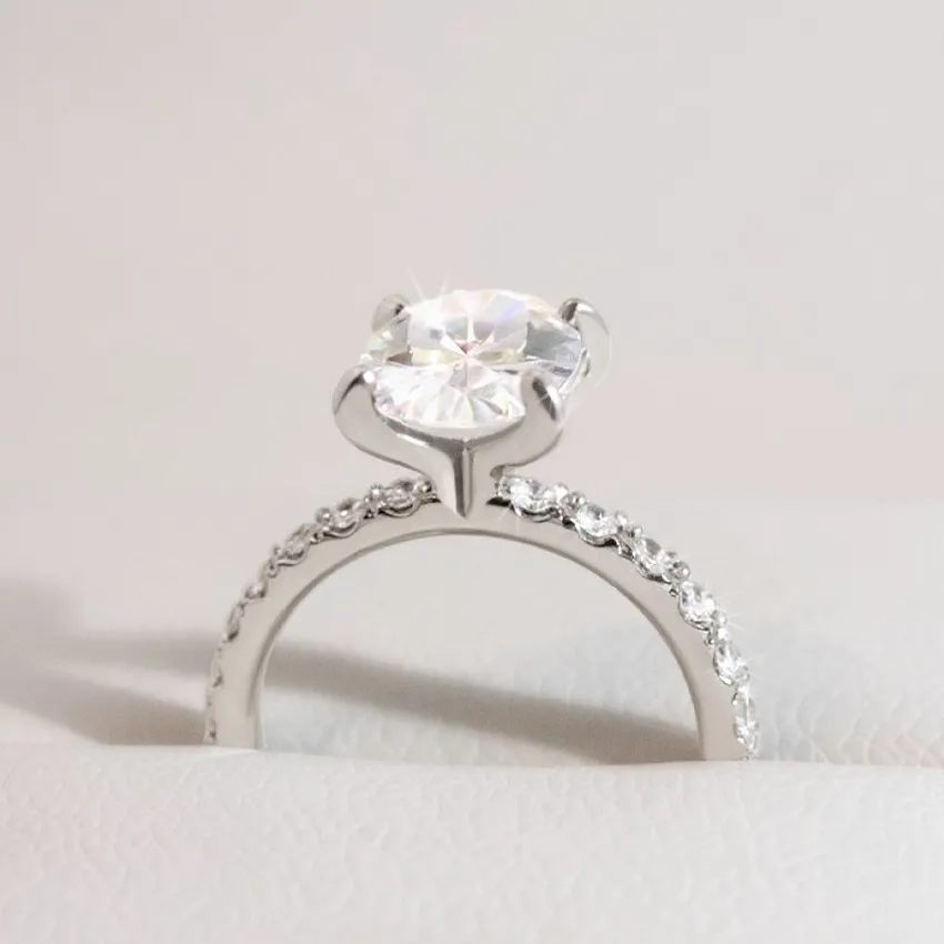 Elegant silver engagement ring with a large center diamond and smaller stones along the band.