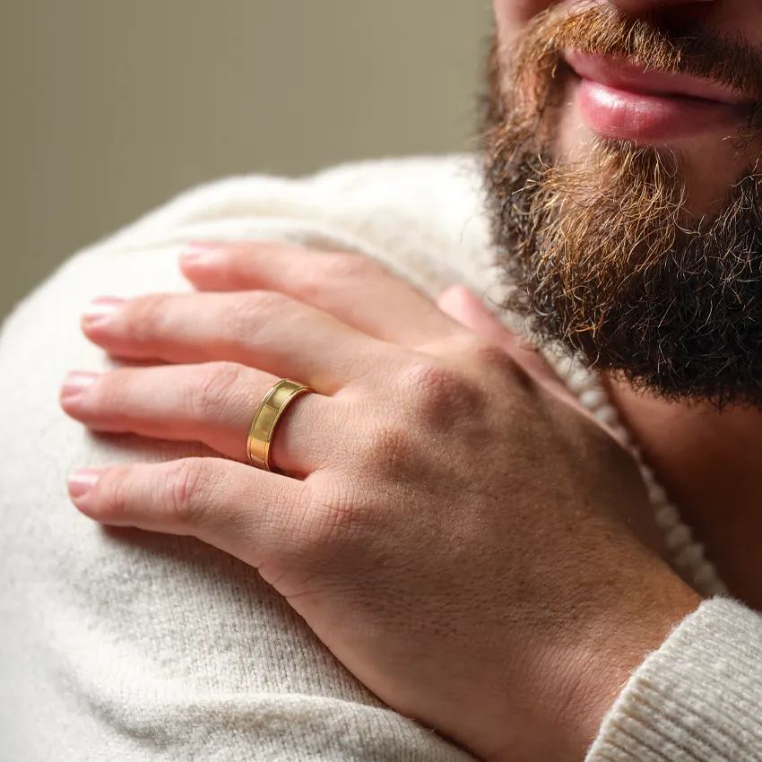 Close-up of a hand with a gold wedding band.