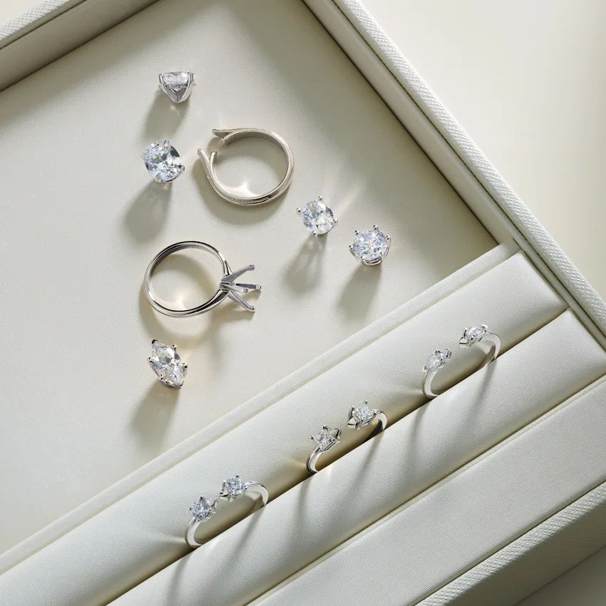 Elegant display of diamond rings and earrings in a jewelry box.