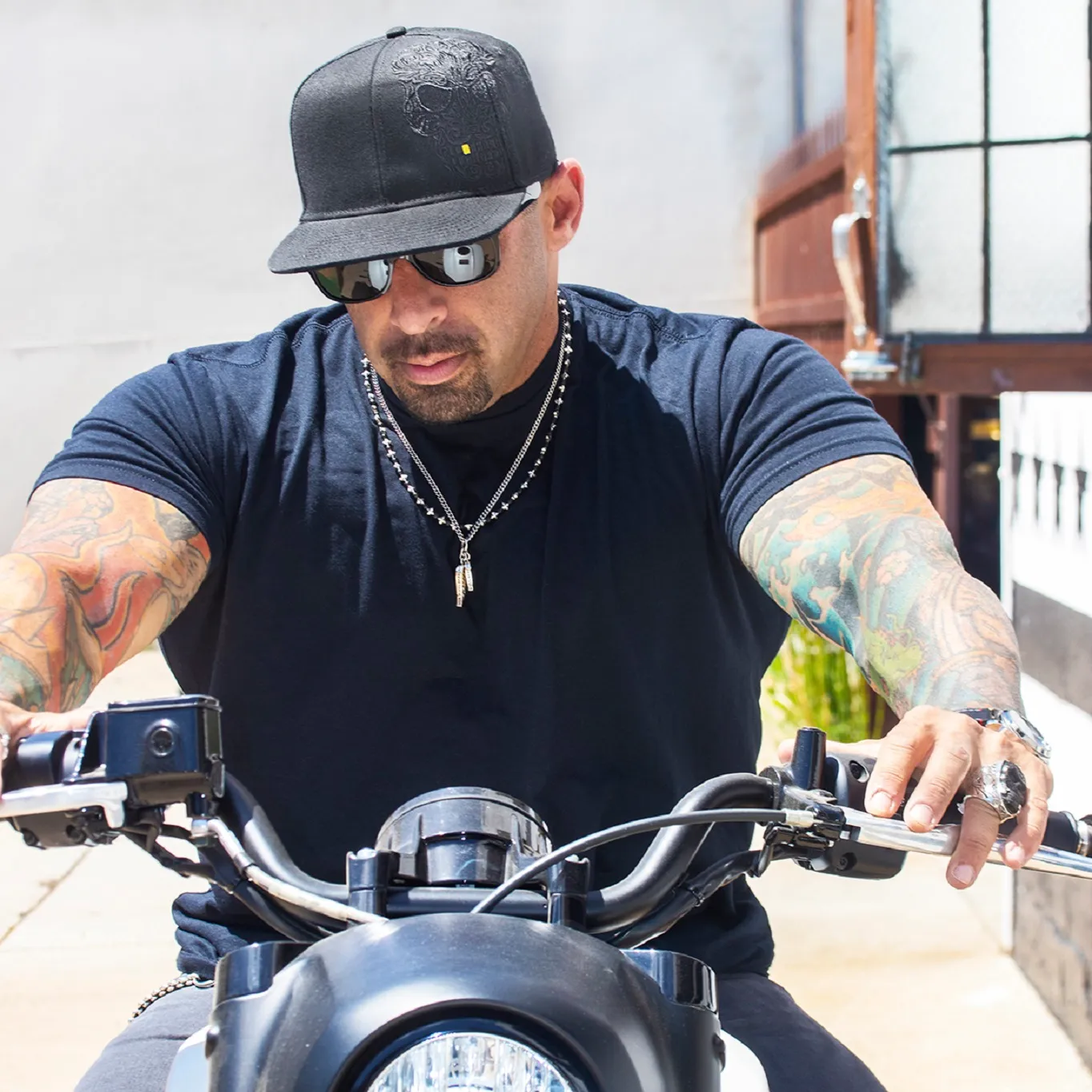 man on a motorcyle while wearing some awesome King Baby jewelry