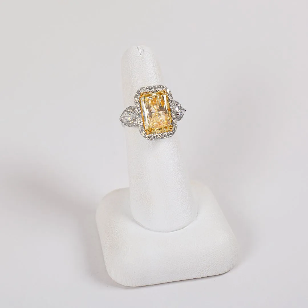  18 Karat White Gold Halo Fashion Ring w/ 7.02 Carat Rectangular Modified Brilliant Shaped Center Diamond with 2 Pear Shaped Accent Diamonds & 64 Round Accent Diamonds Bay Area Diamond Company Green Bay, WI