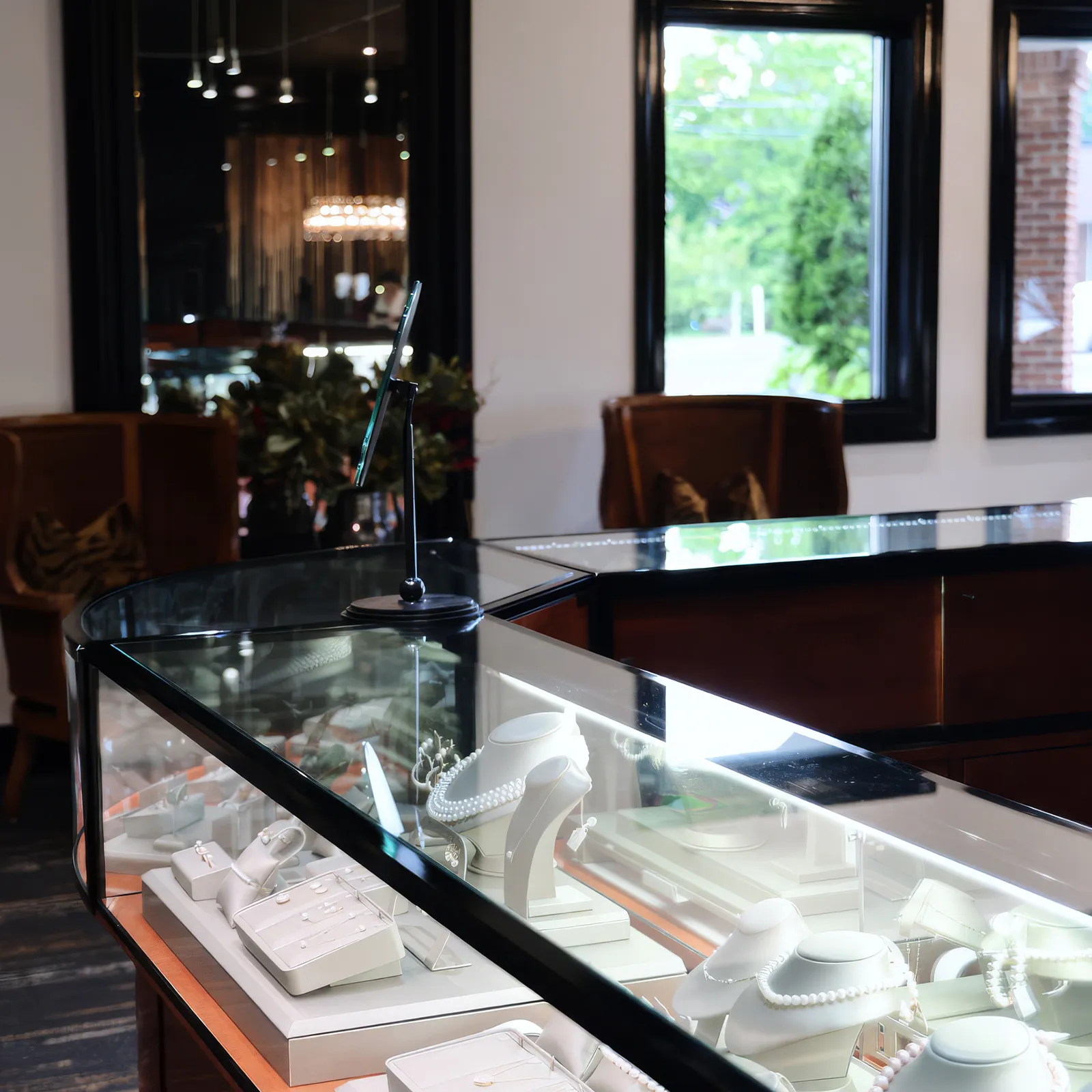 Jewelry display case with necklaces and earrings in a store setting.
