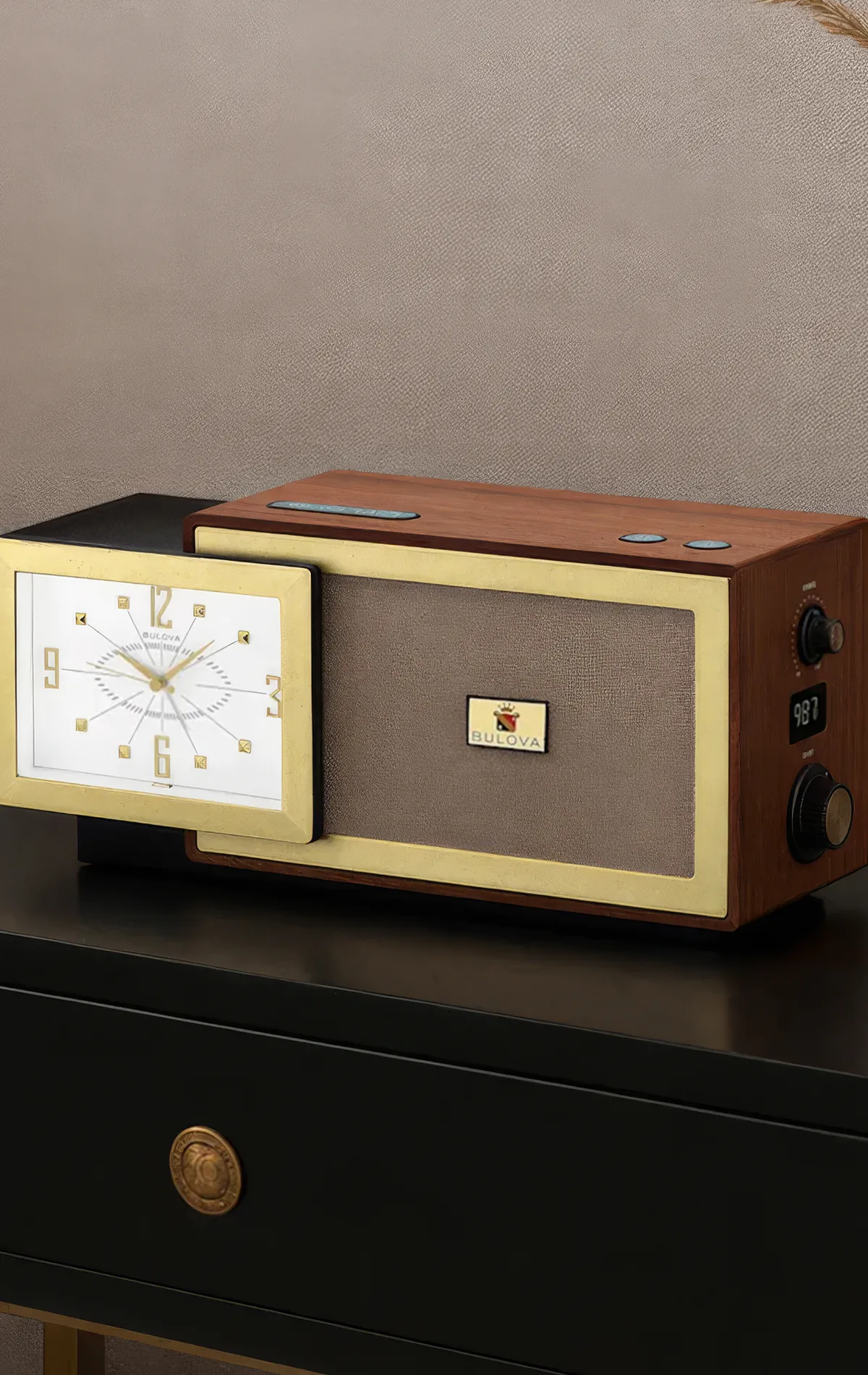 Vintage-style Bulova clock radio with wood and brass accents on a black table.