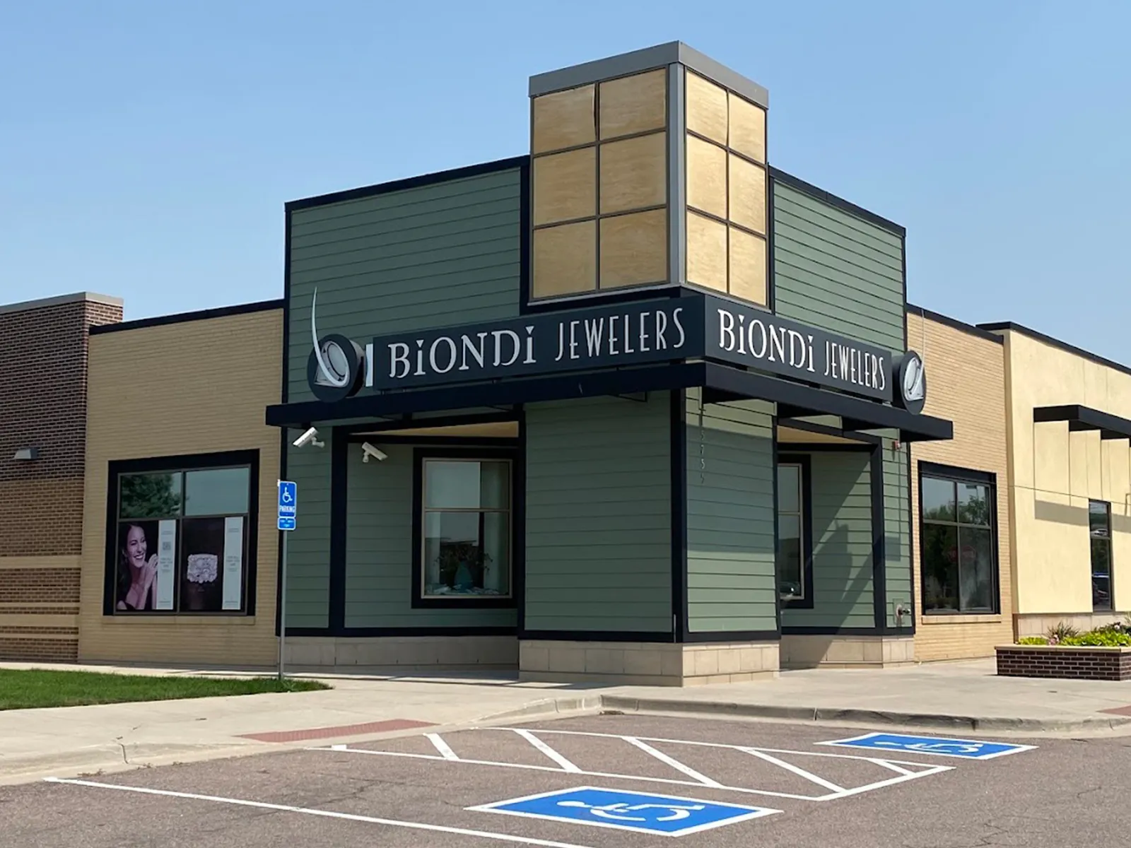 Biondi Jewelers store exterior with signage and accessible parking spaces.