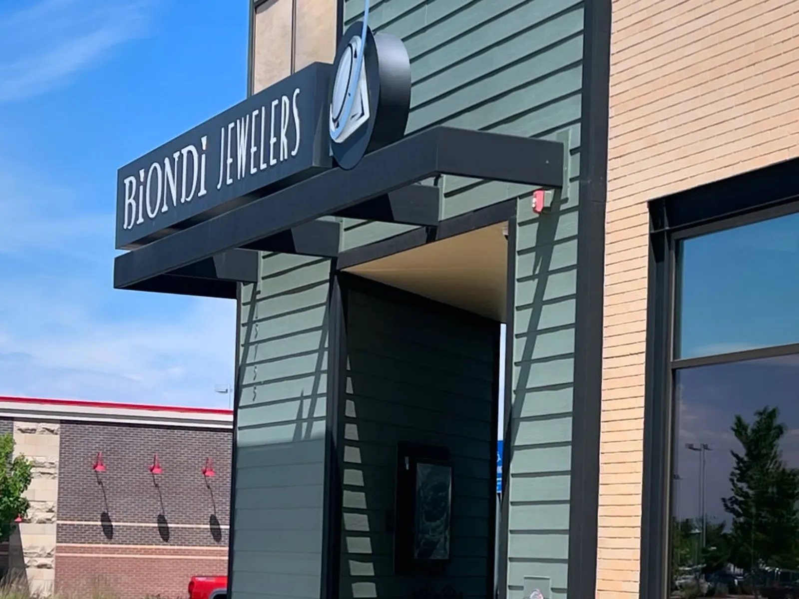 Biondi Jewelers storefront with a modern sign and building exterior.