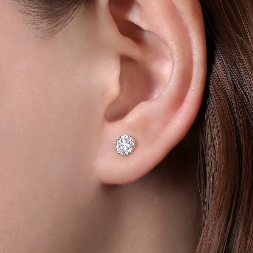 Close-up of a woman's ear wearing a sparkling lab-grown diamond stud earring.
