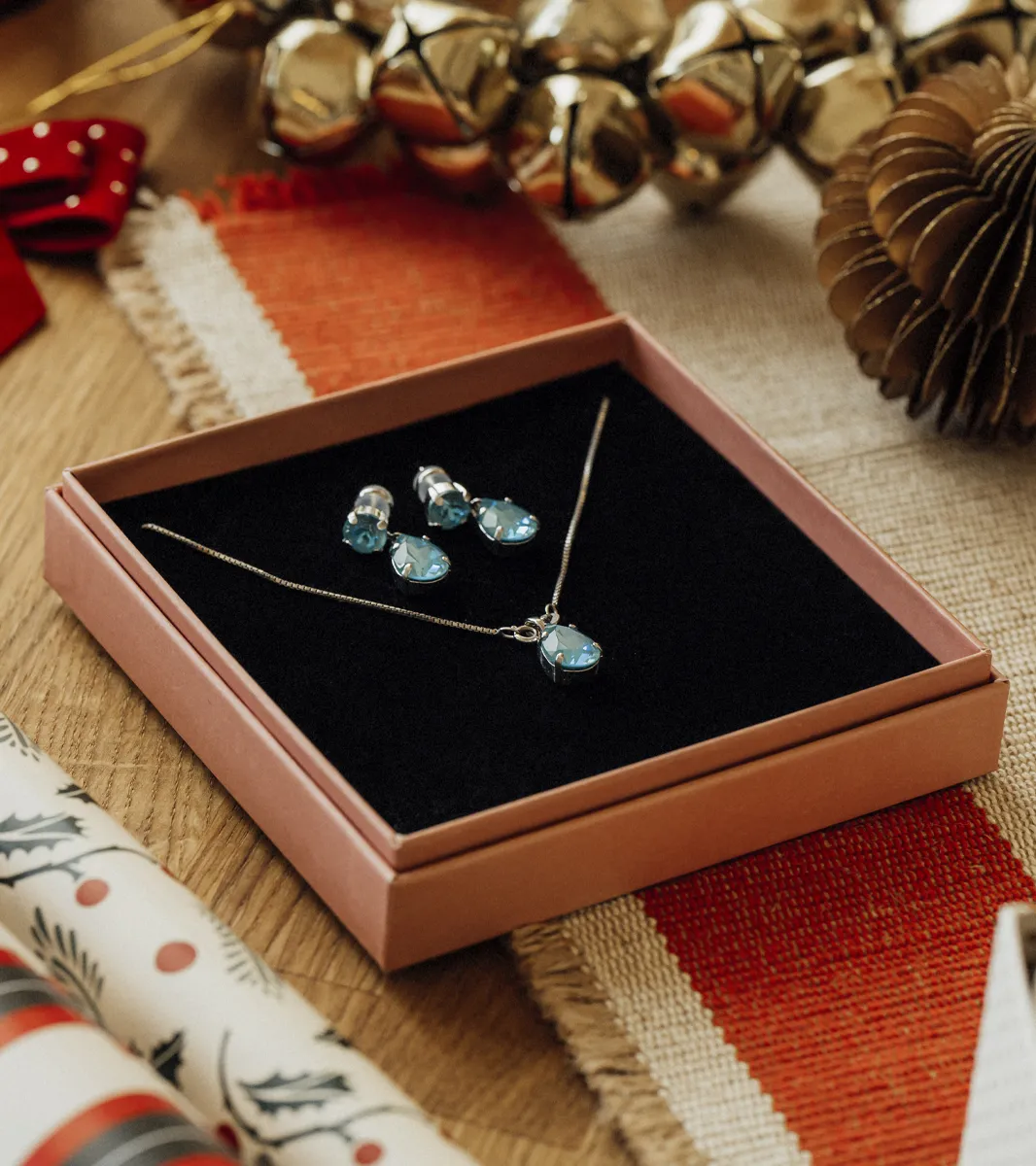Blue Water Jewelers gift set featuring a necklace and earrings with blue gemstones, perfect for holiday gifting.