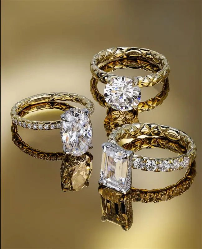 Hands with wedding rings, one with a diamond, symbolizing marriage.