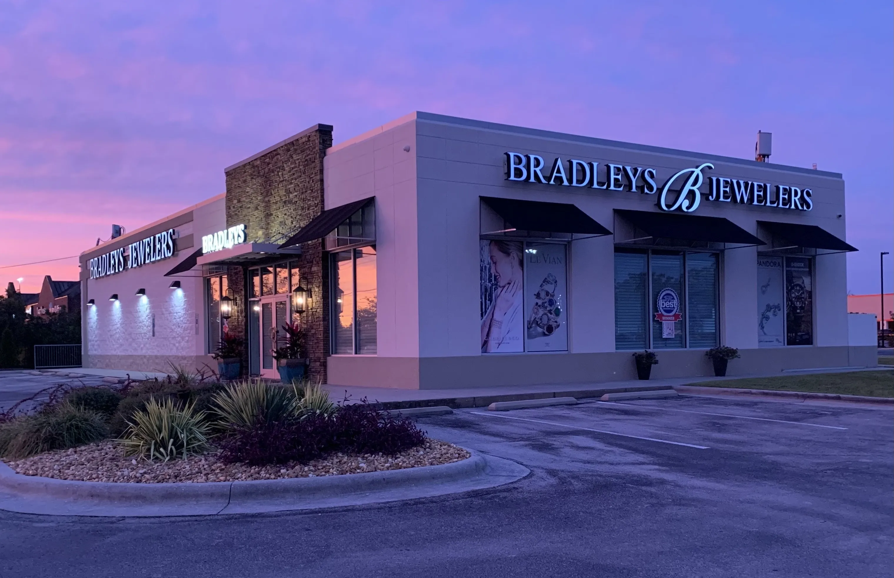 Exterior of Bradley's Jewelers in Jacksonville with illuminated signage and storefront displays.