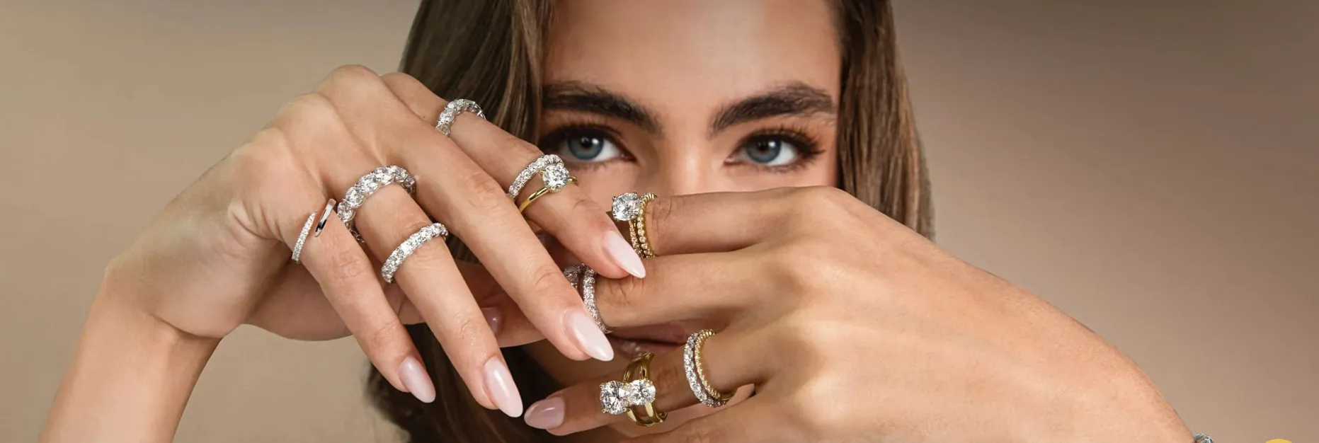 Hands with wedding rings, one with a diamond, symbolizing marriage.